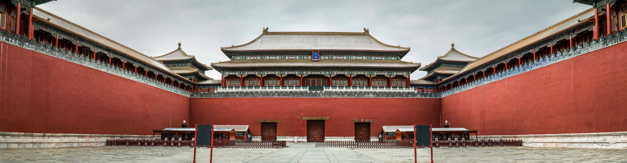 The red walls and intricate roof of Forbidden City after snow, Beijing, China.