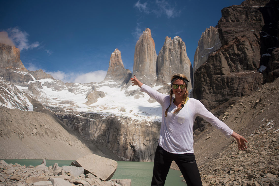 Woman posing in front of the Cordillera Paine mountains, Torres del Paine NP