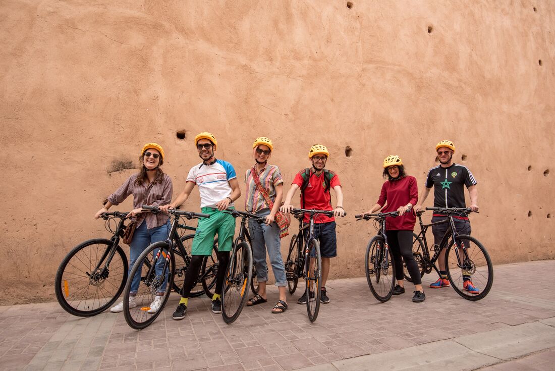 Group of Intrepid travellers prepared to head out from Marrakech while cycling