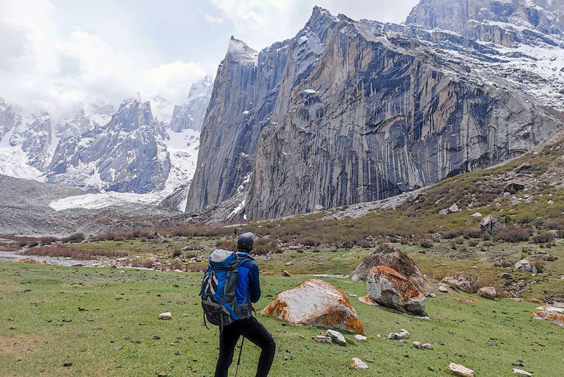 Hiker admiring the mountain peaks of the Nangma Valley, Pakistan