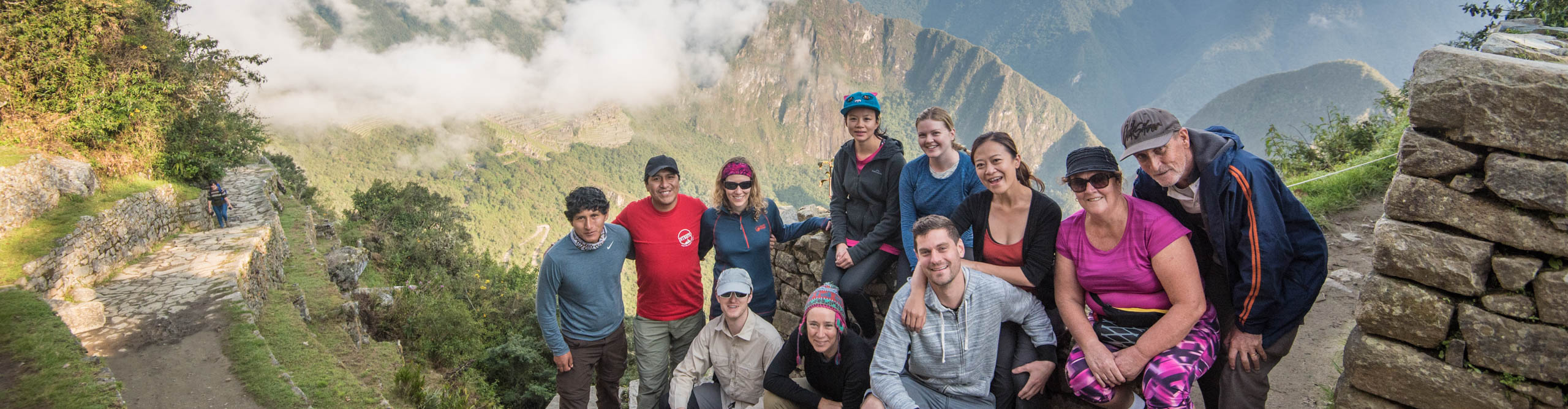 Hikers in a group photo with their guide on the trek to the Sun Gate at Machu Picchu, Peru