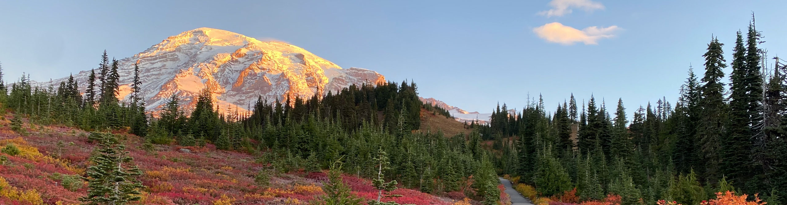 hikers at mount rainier with fall colors at sunset 