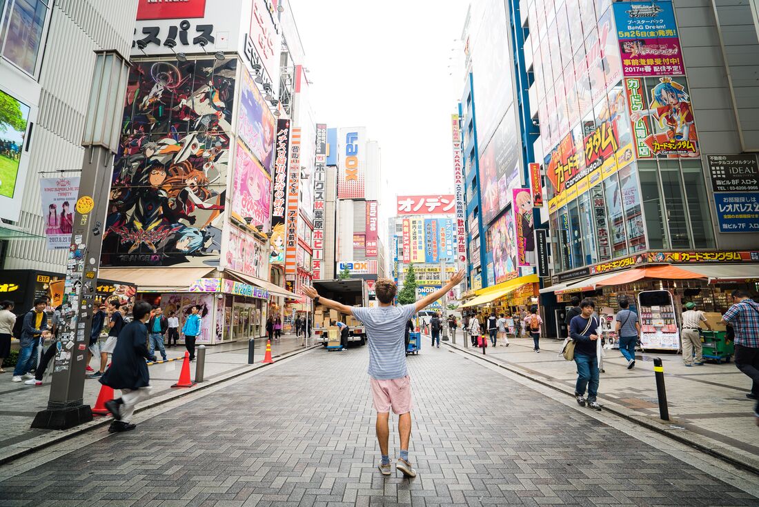 Traveller walks around anime district in Tokyo