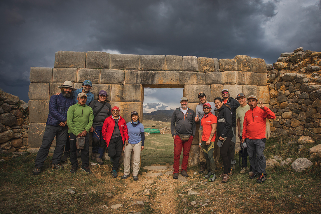 Group posing for a photo in front of some ruin on the Great Inca Road, Peru