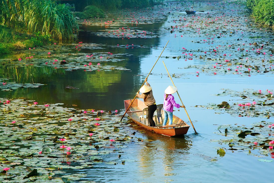 Locals cruising on the river in Hanoi