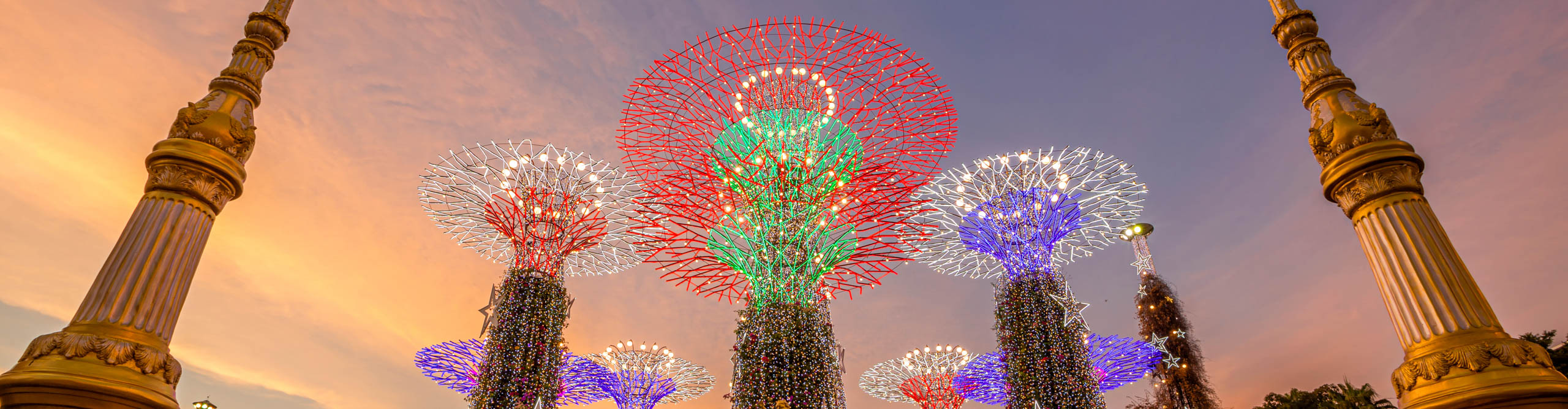The colourful lights of the Supertree Grove in Gardens by the Bay at twilight time, Singapore