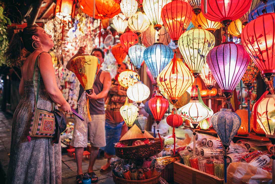 Passenger looks at lanterns from street vendor in Hoi An