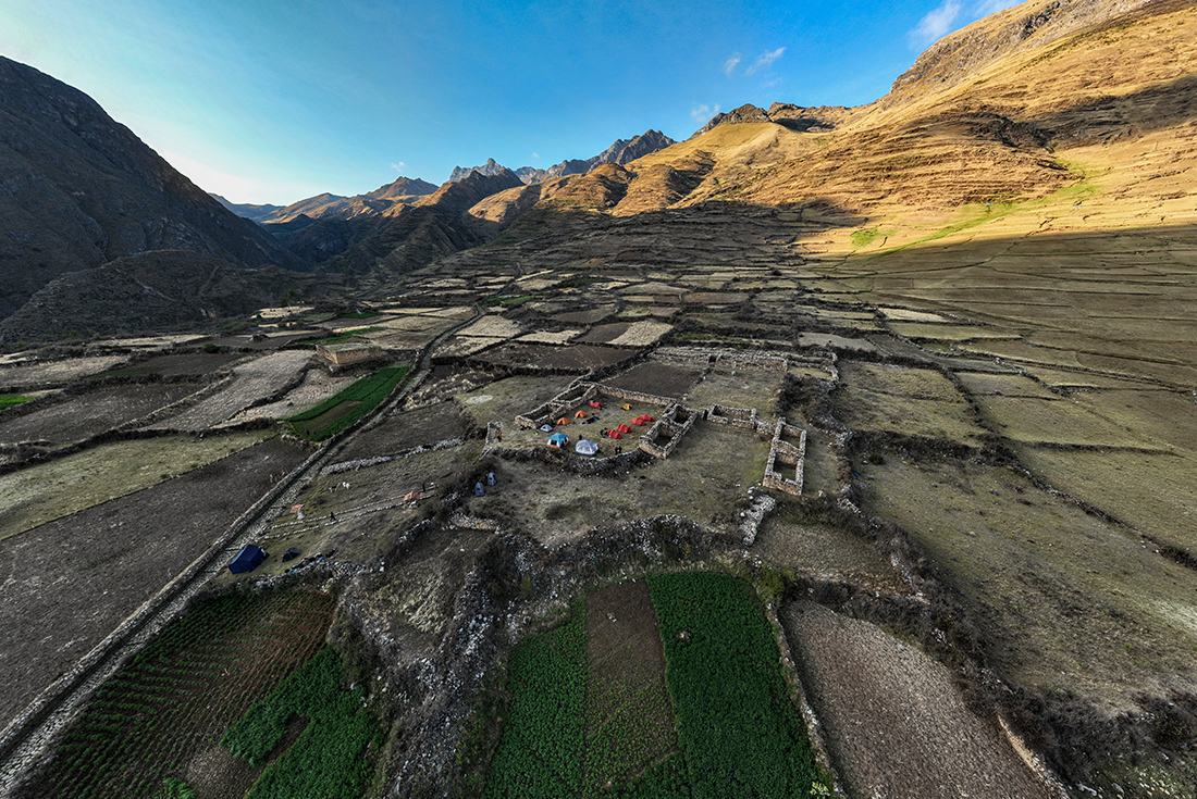 Aerial photo of the campsite amongst ruins in a valley on the Great Inca Road, Peru