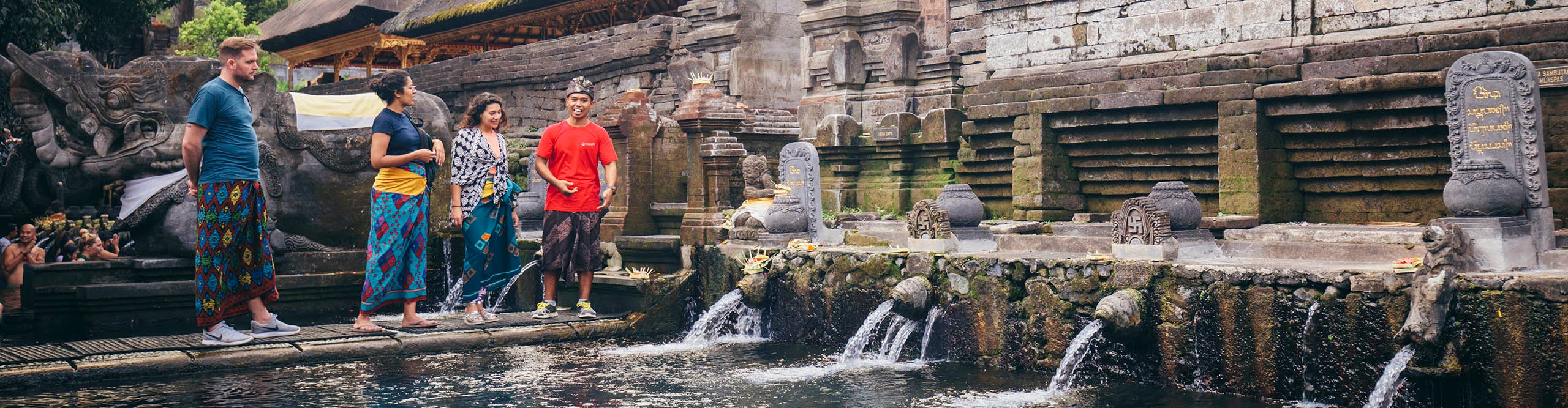 Tourists with their guide at a temple in Bali 