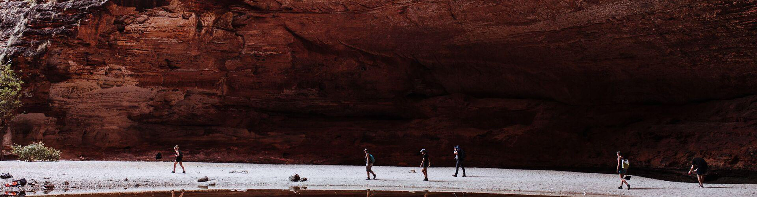 Group walking through a cavern in the Kimberley's, Western Australia 