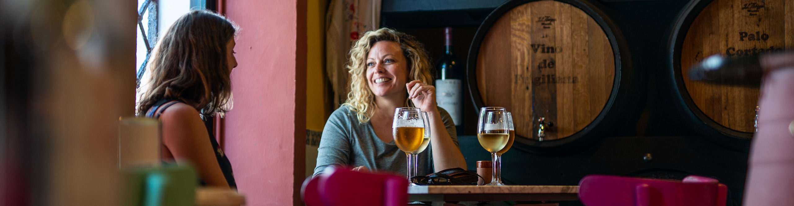 woman drinking wine in a bar in Spain 