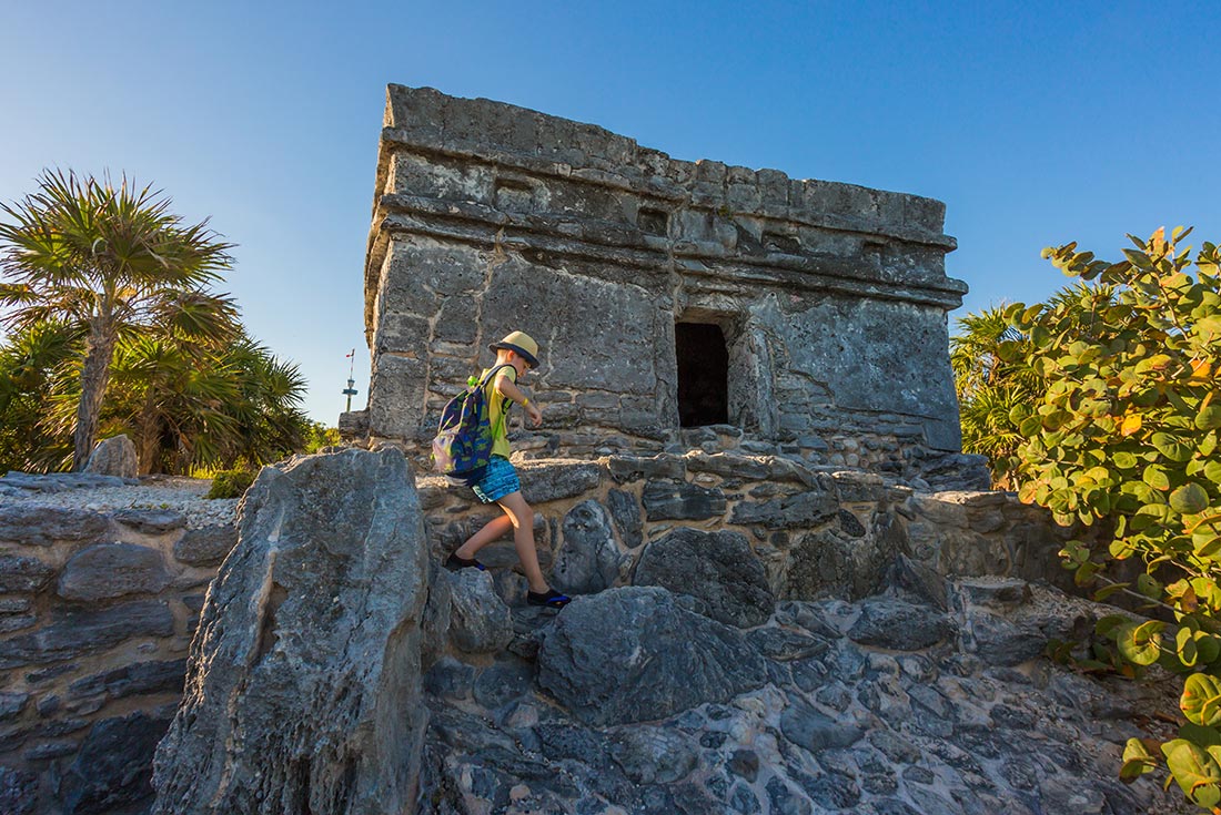Kid climbing ruins in Tulum, Mexico
