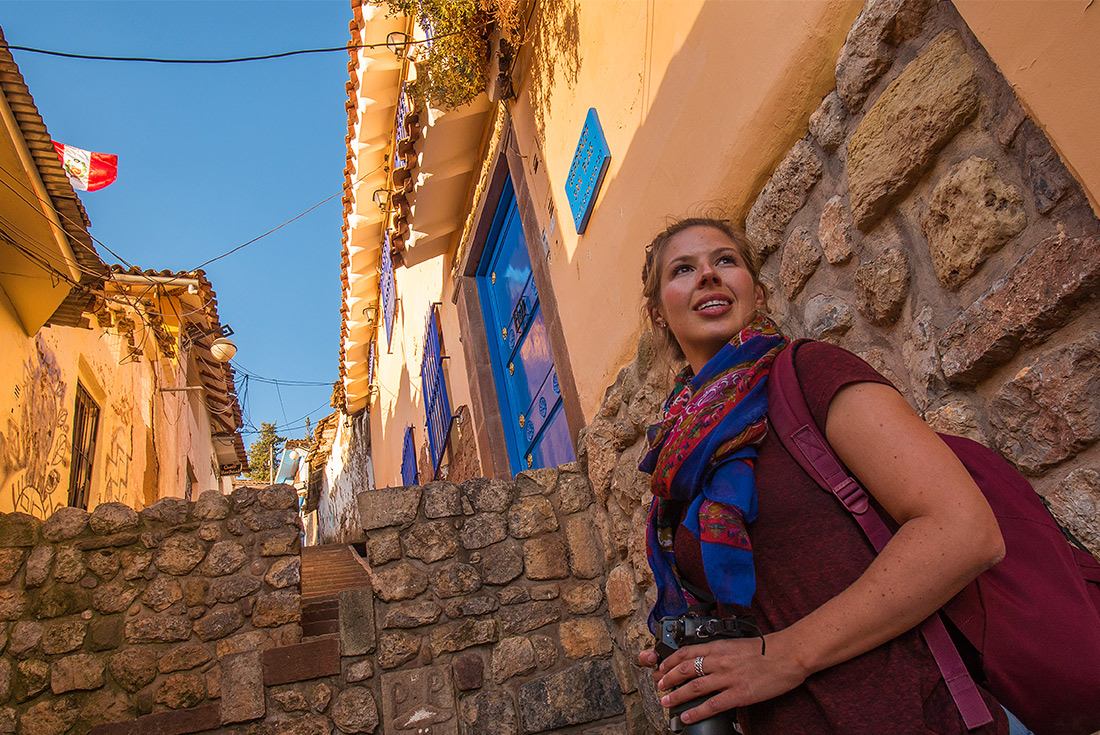 Traveller woman exploring cobbled streets of Cusco, Peru