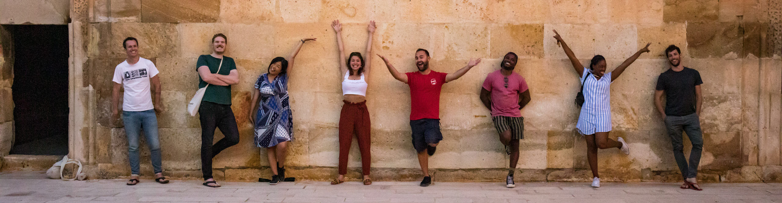 Group having a photo taken with arms outstretched in Goreme, Turkey 