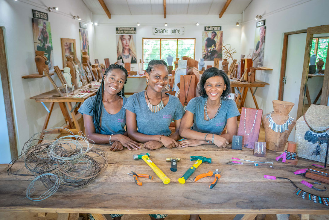 Women making jewellery in Luangwa NP with found snare wire, Zambia