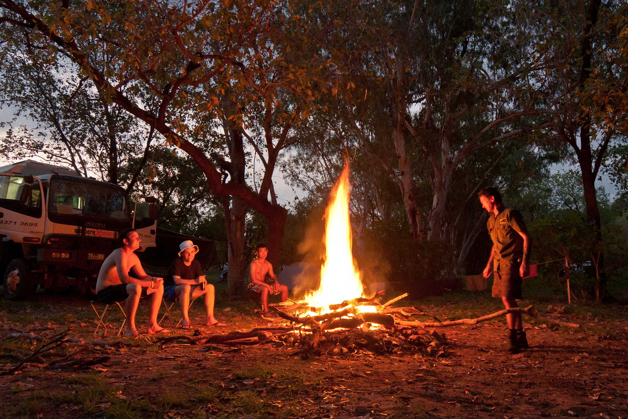 Friends around a campfire at El Questro, Western Australia