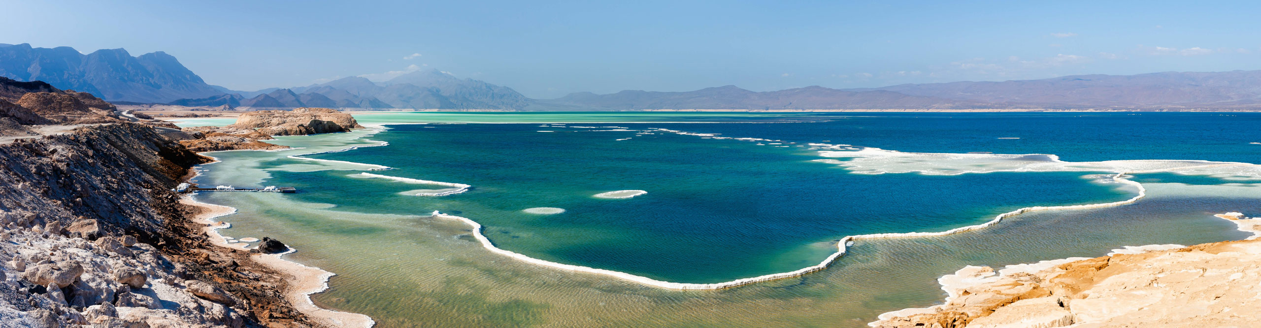 Salty Coastline of the Blue Lake Assal, with mountains in the distance, Djibouti, Africa