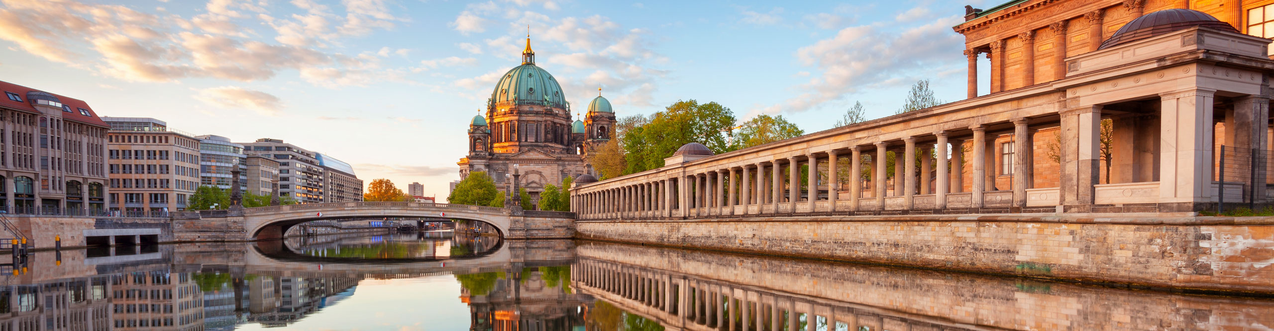 Berlin Cathedral and Museum Island in Berlin during sunrise, reflected in the river