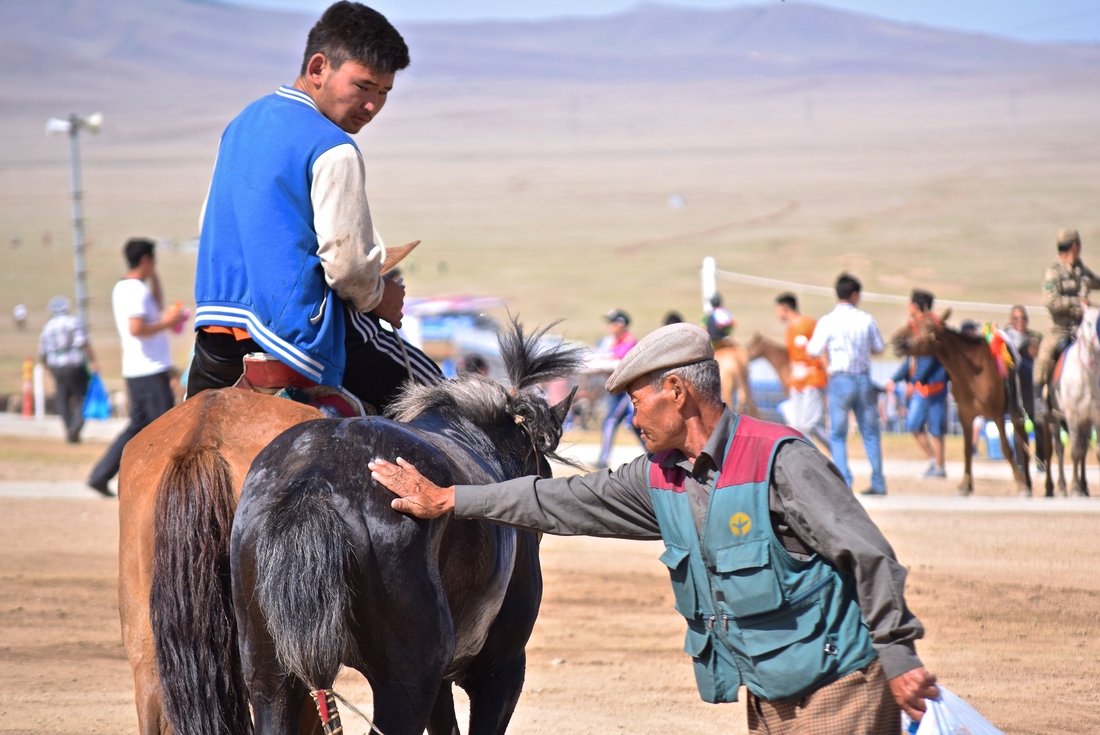 Intrepid Travel mongolia local collecting horse sweat for good luck