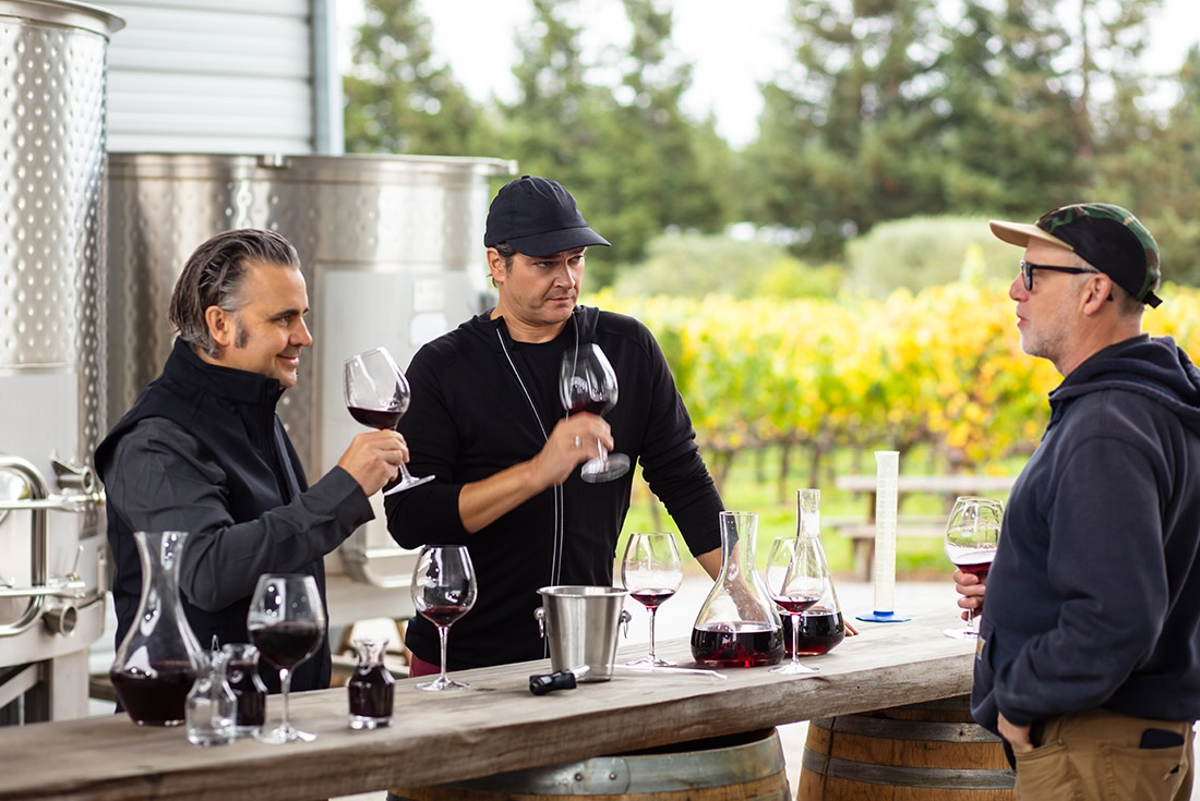 Male travellers wine tasting at a vineyard in California, U.S.A.