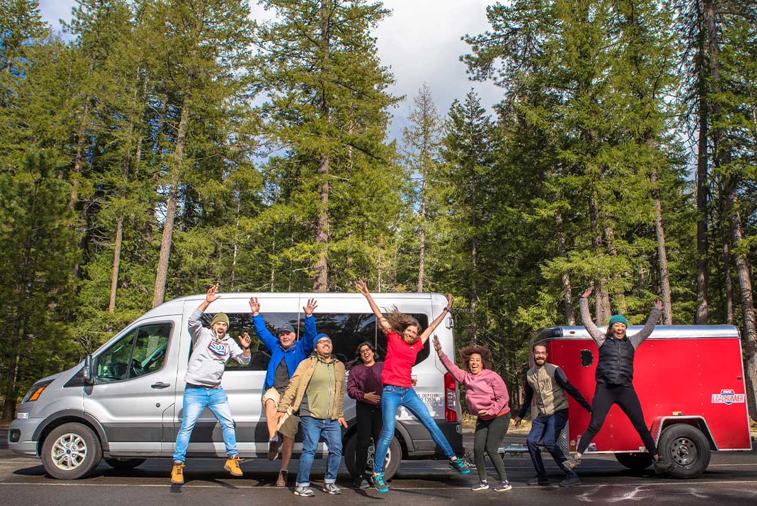 Group at Crater Lake NP in front of private transportation, Oregon, USA