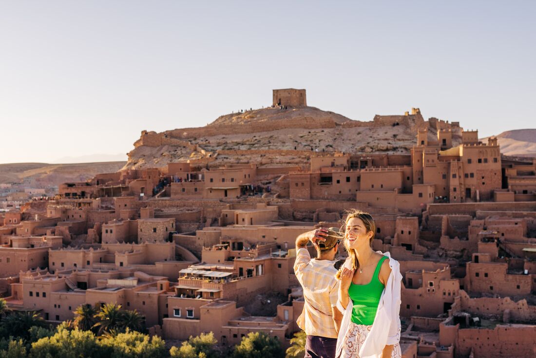 Travellers and leader overlook the city of Ait Benhaddou, Morocco