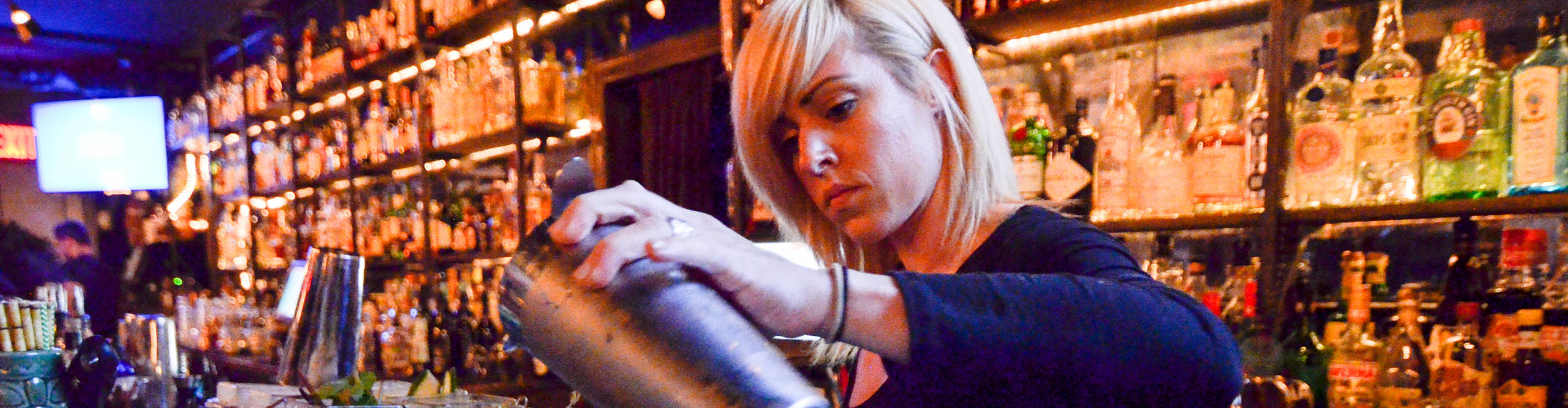Bartender pouring a drink in a bar in New York,  USA