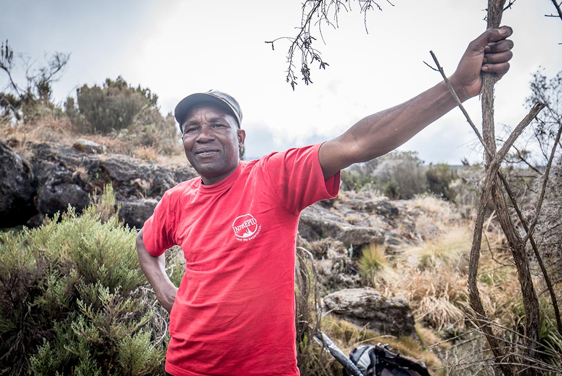 Intrepid guide taking a break on the hike to the summit of Mt Kiliminjaro, Tanzania