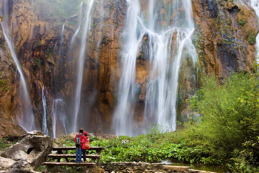Travellers admiring the waterfall in Plitvice Lakes national park, Croatia