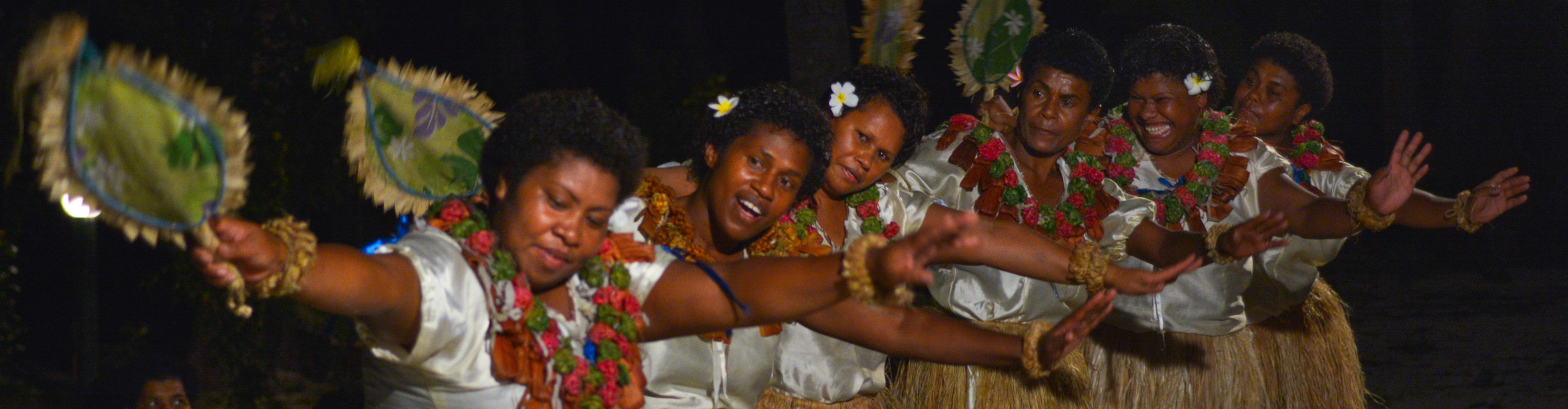 Group of women in traditional clothe dancing on stage in Fiji 