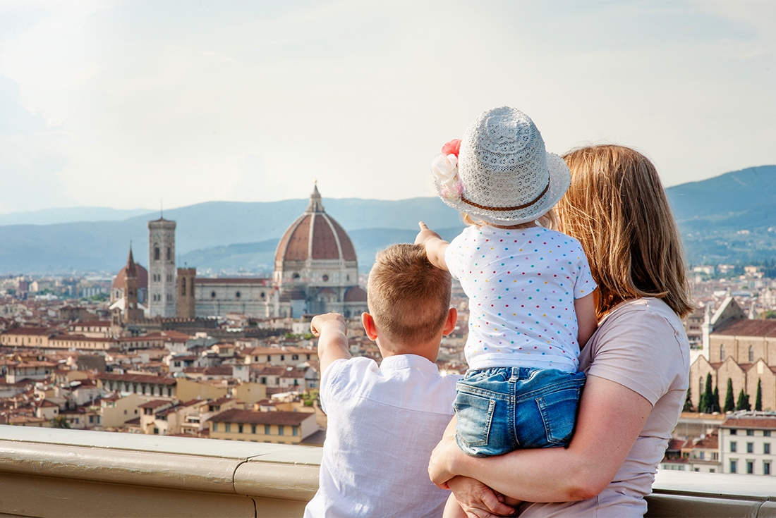 Family looking out over Florence, point at the Duomo di Firenze in Florence.