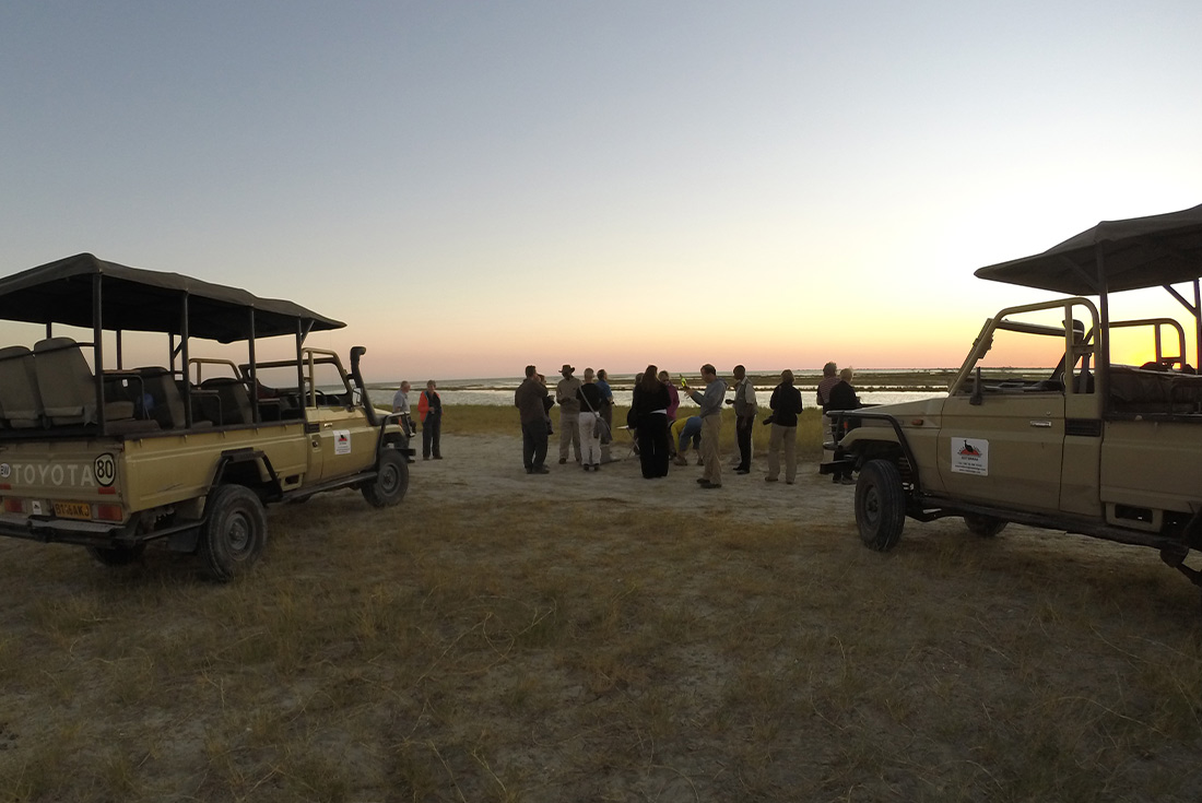 Travellers exploring the Makgadikgadi Salt Pans by 4x4 vehicles, Botswana, Africa