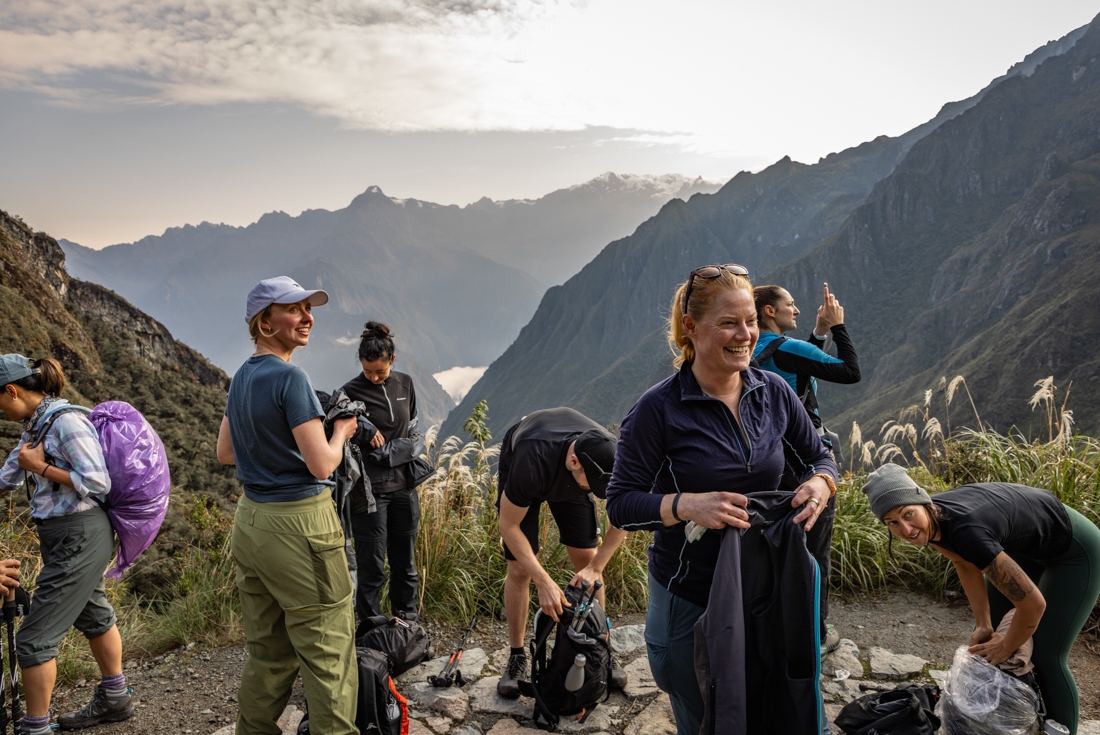 Intrepid travellers laugh and wonder at a checkpoint in the mountains on the Inca Trail
