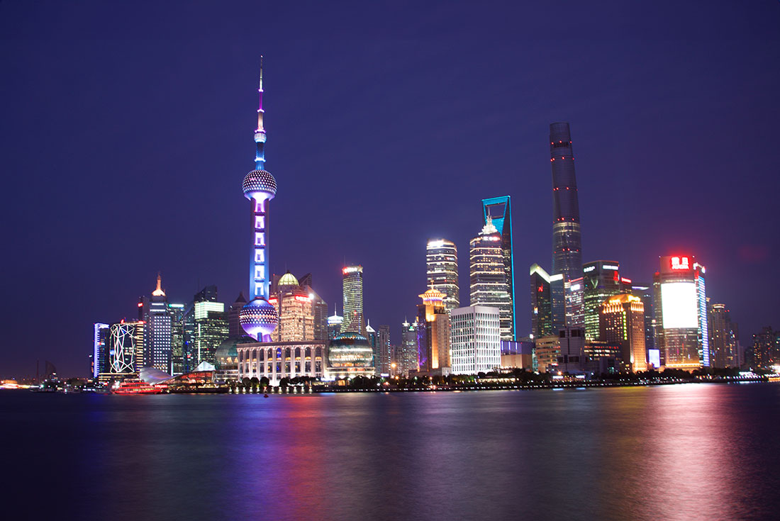 The Shanghai skyline at night across the water