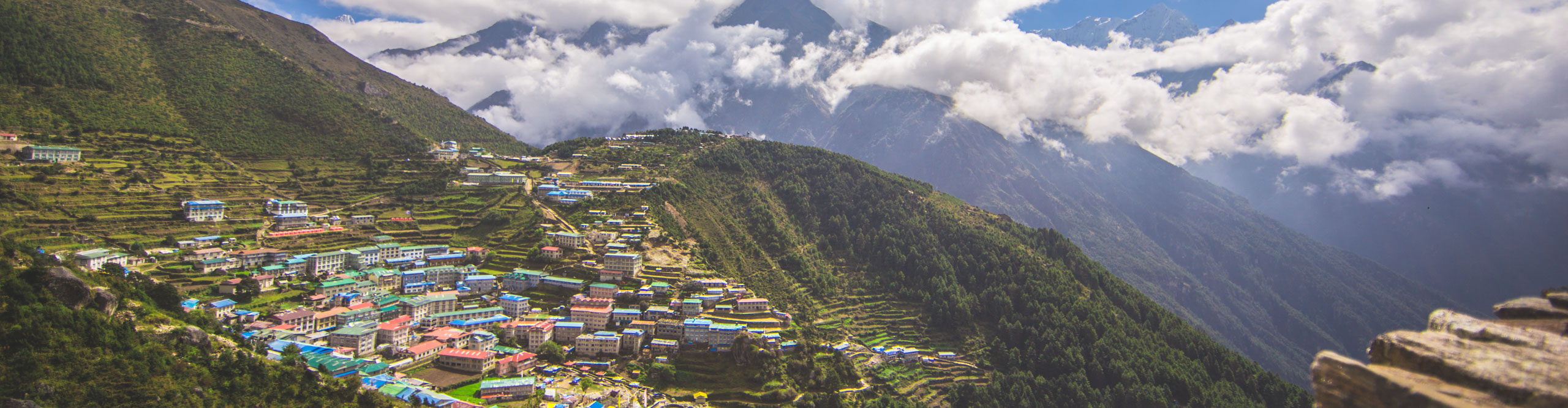 View of city on the side of a mountain in Nepal, on a cloudy day 