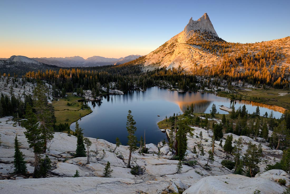 Calm Cathedral Lake and rock at sunrise in Yosemite NP