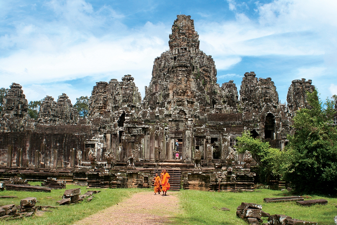 Monks walk around the temples of Angkor Wat