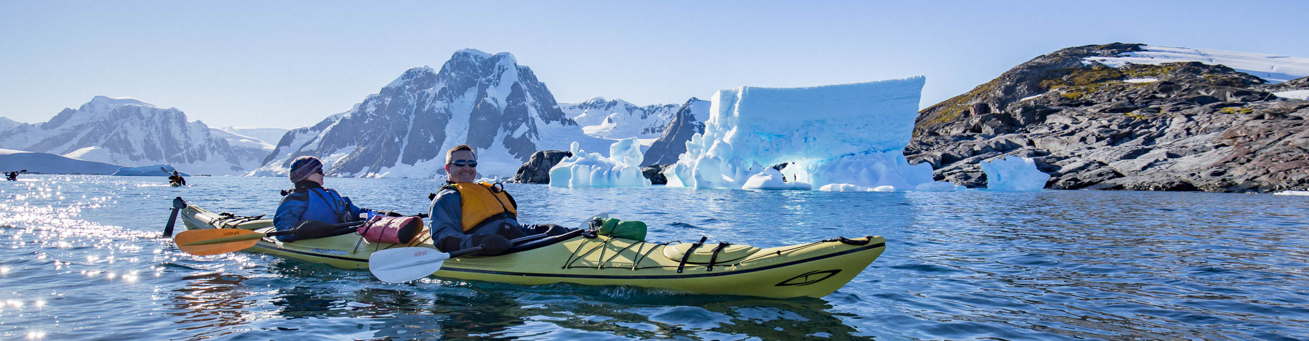 Group kayaking through the icebergs in Antarctica 
