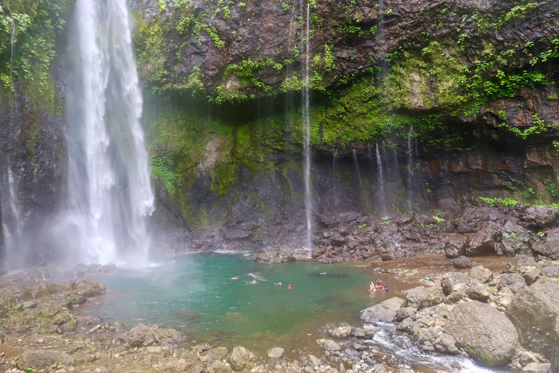 Intrepid travellers swim at the base of Savulelele Waterfall near Nabalasere village