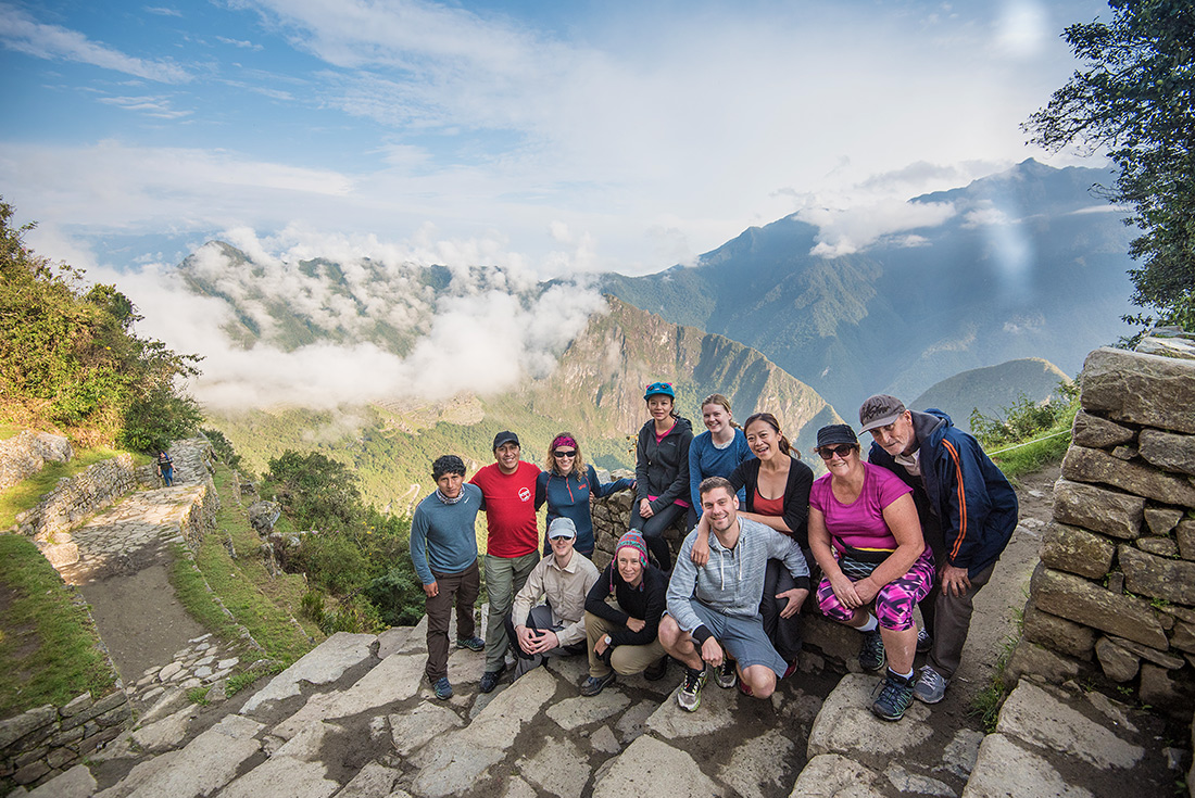 Group of travellers with view of Machu Picchu, Peru