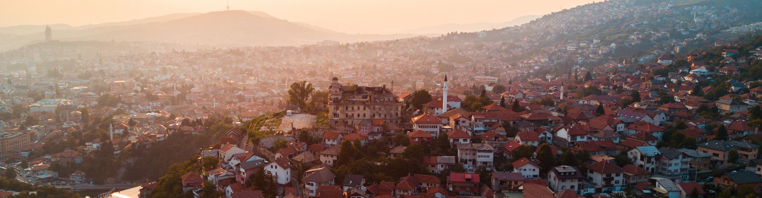 Aerial view of Sarajevo cityscape against mountain during sunset, Bosnia and Herzegovina, Europe
