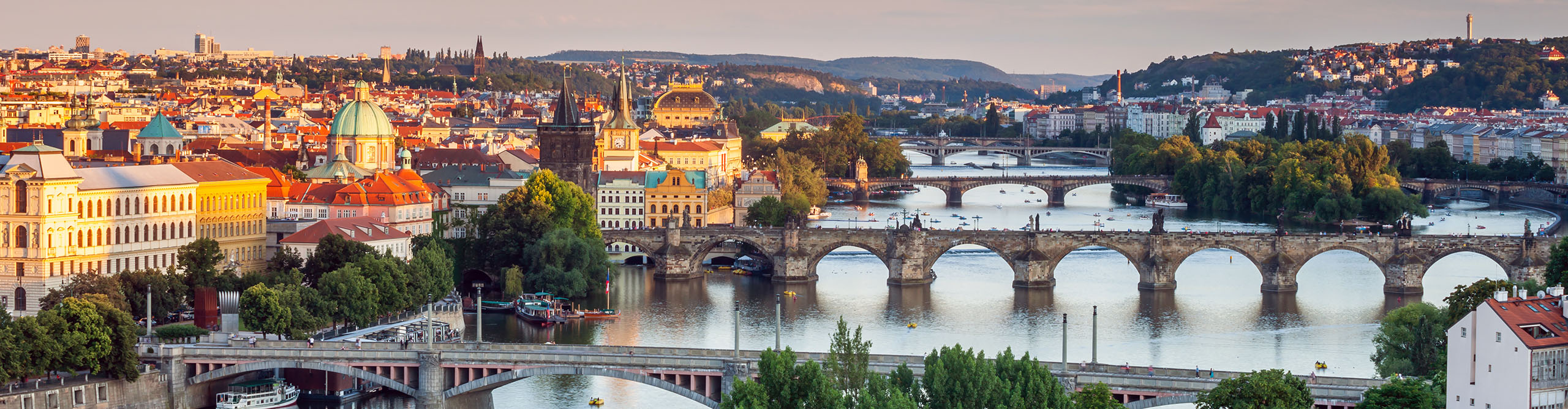 Aerial view of Prague at sunset over Charles Bridge on a summer evening