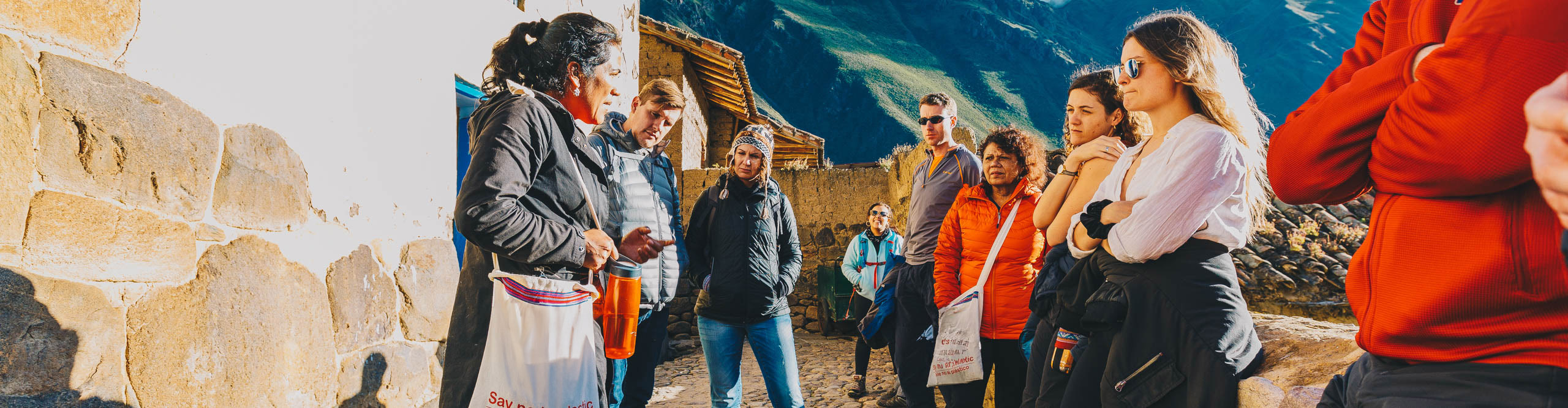 Group standing n talking wit their guide in Ollantaytambo, Peru 