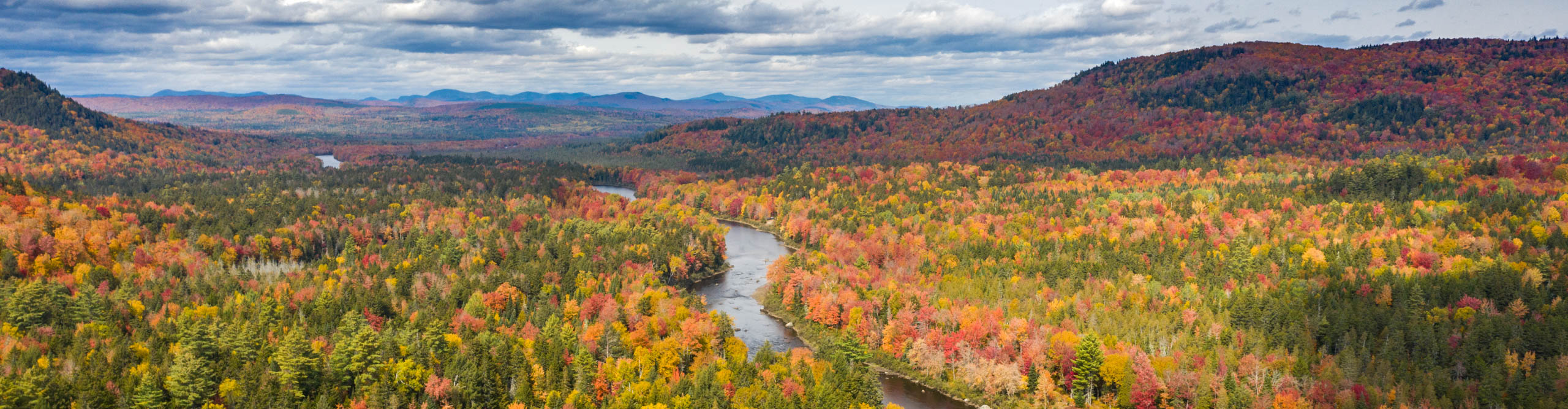 View of Dead River autumn landscape, with orange, green and red trees, Maine,United States,USA