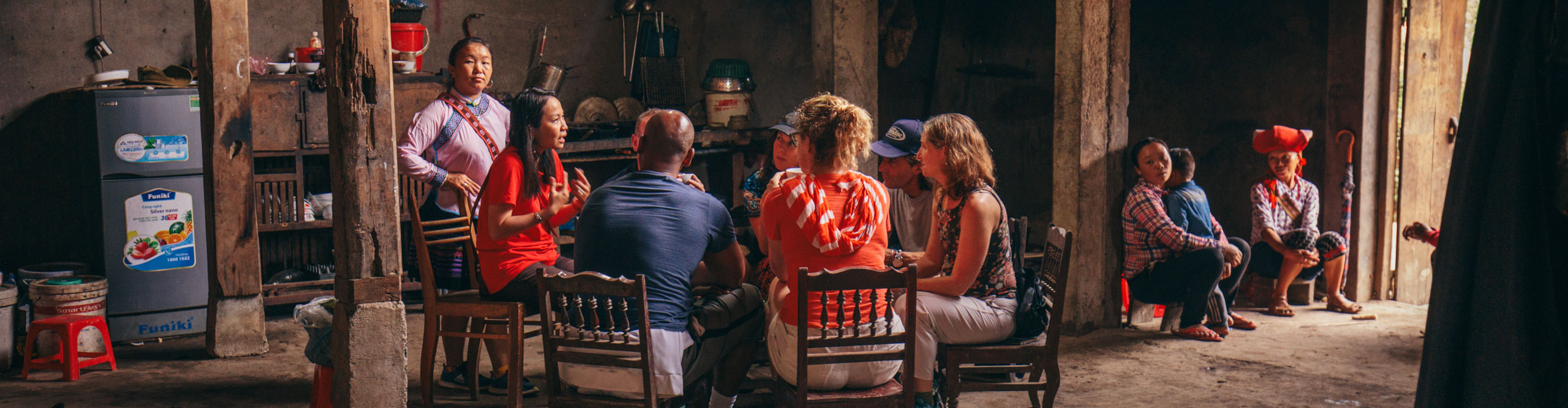 People sitting and talking with a local at a homestay in Sapa, Vietnam 