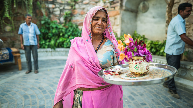 A woman holding flowers in India