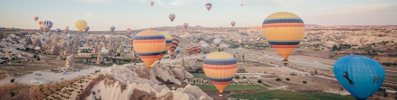 Balloons flying over Cappadocia, Turkey, as the sun rises