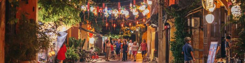 Travellers walk the streets of Hoi An, Vietnam