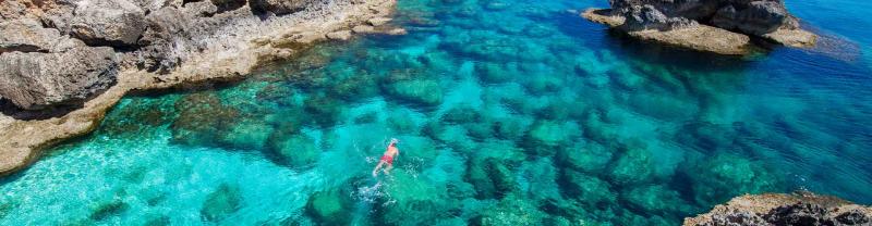 Traveller goes for swim in the waters of ayia napa, cyprus