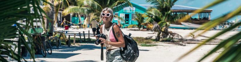 Traveller takes photos on beach in belize